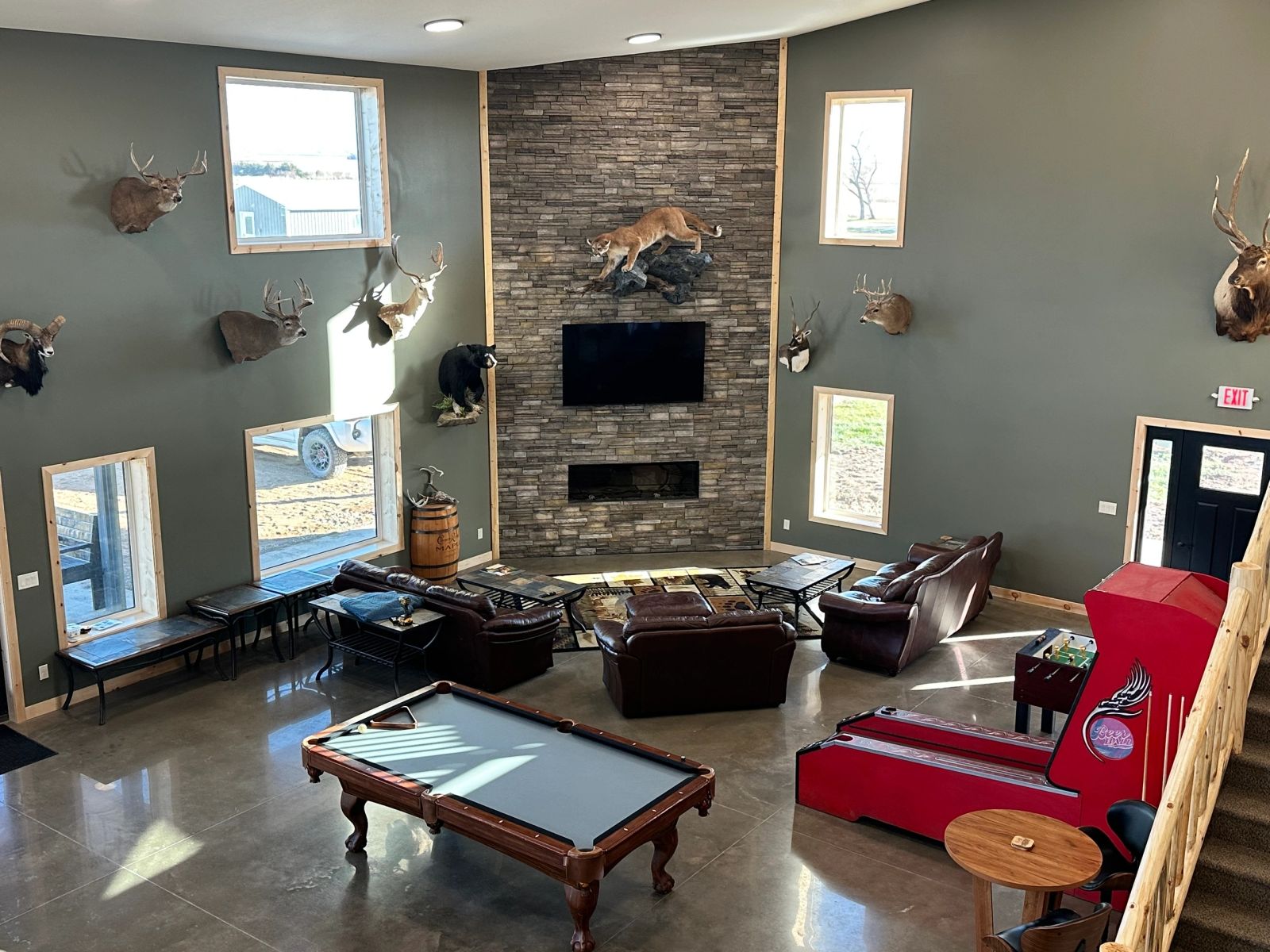 Leather lounge seating and mounts in the Coteau View hunting lodge great room